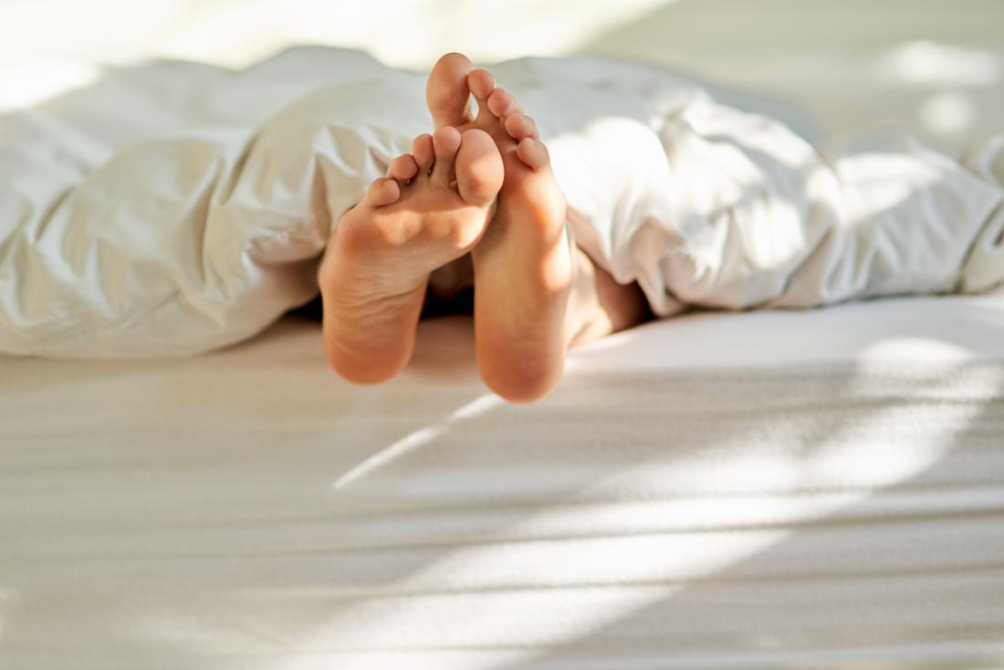 feet peeking out from under the sheets