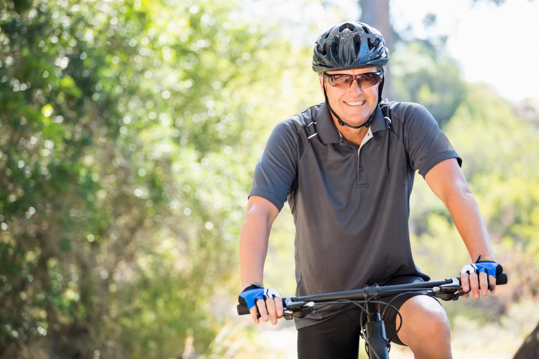 Older man cycling to try and lose visceral fat