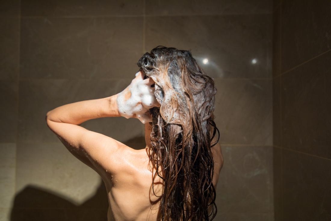 lady in the shower washing her hair