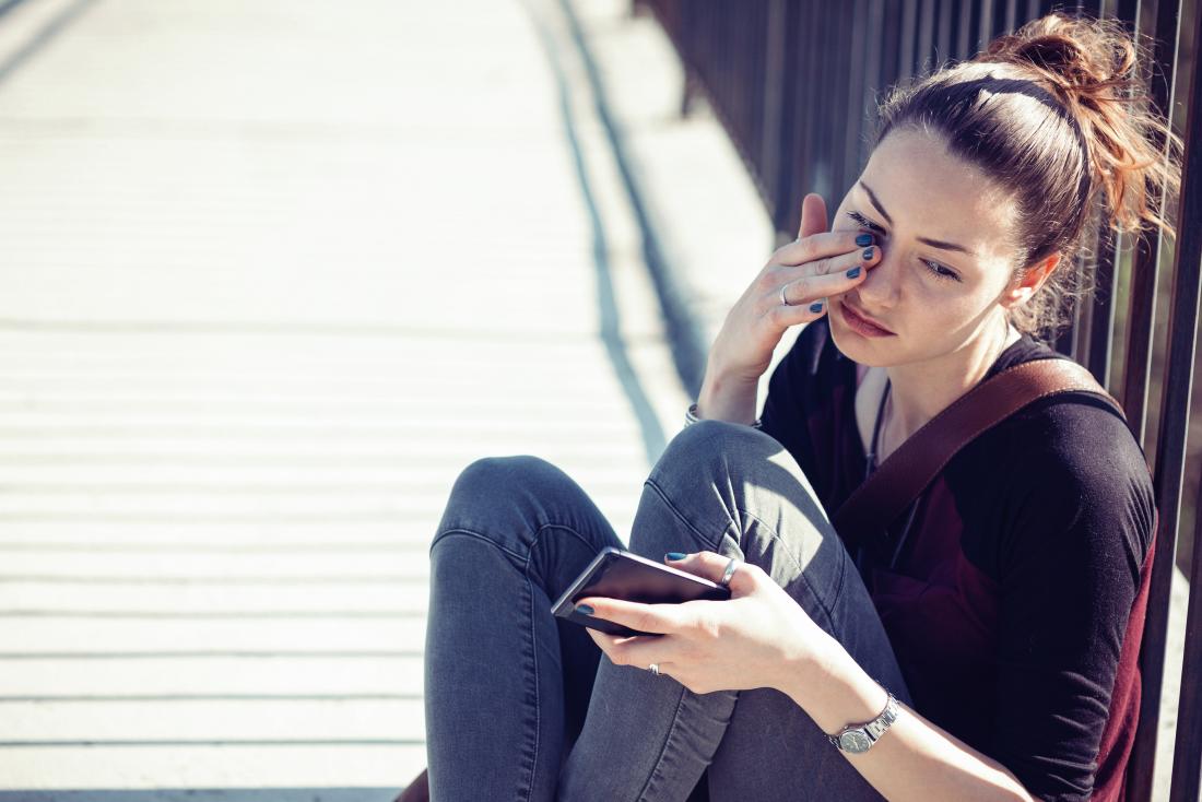 young woman rubbing her eye