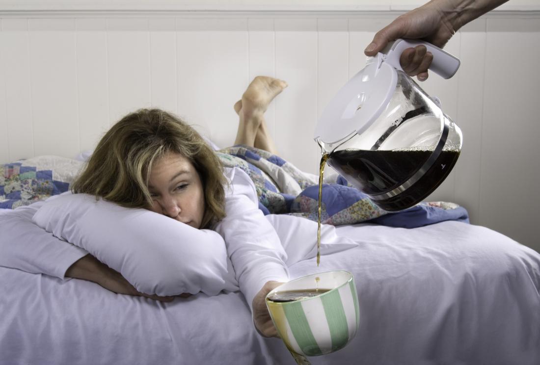 woman in bed drinking coffee which may help to sober up
