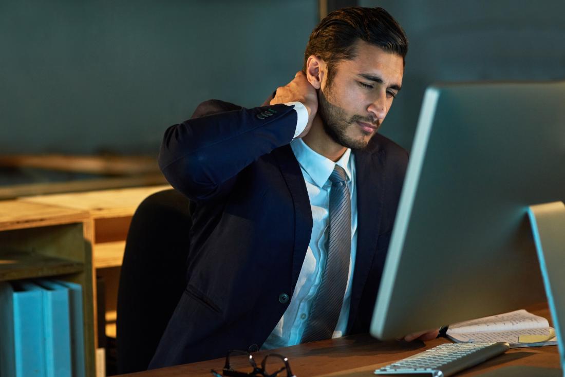 Man with neck muscle ache sitting in office chair.