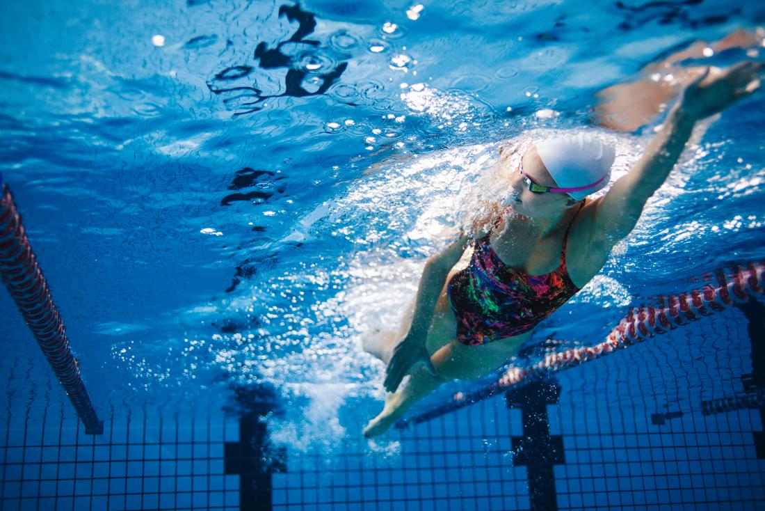 Woman swimming in pool.