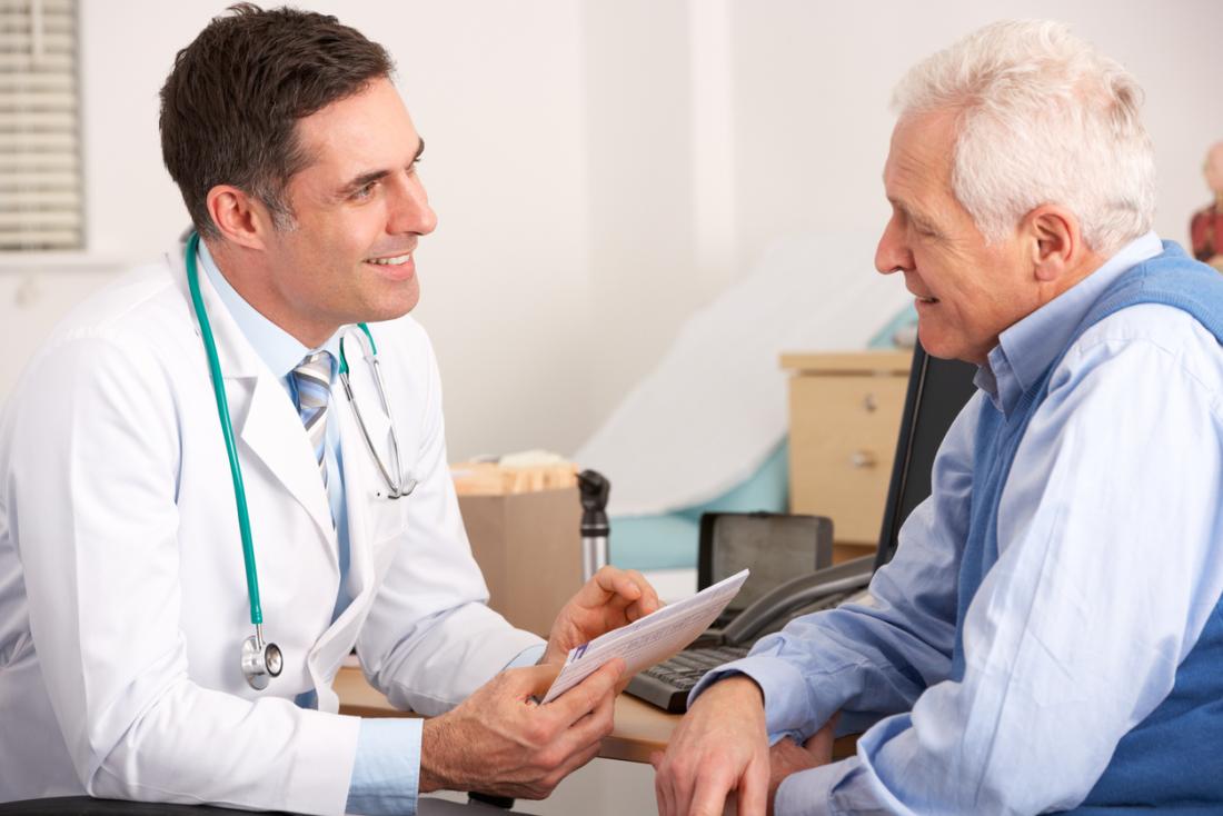 a senior man discusses with a doctor