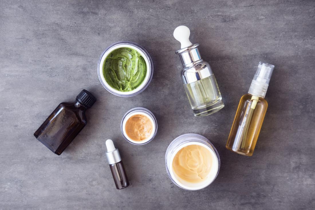 Different natural skincare products on stone background.