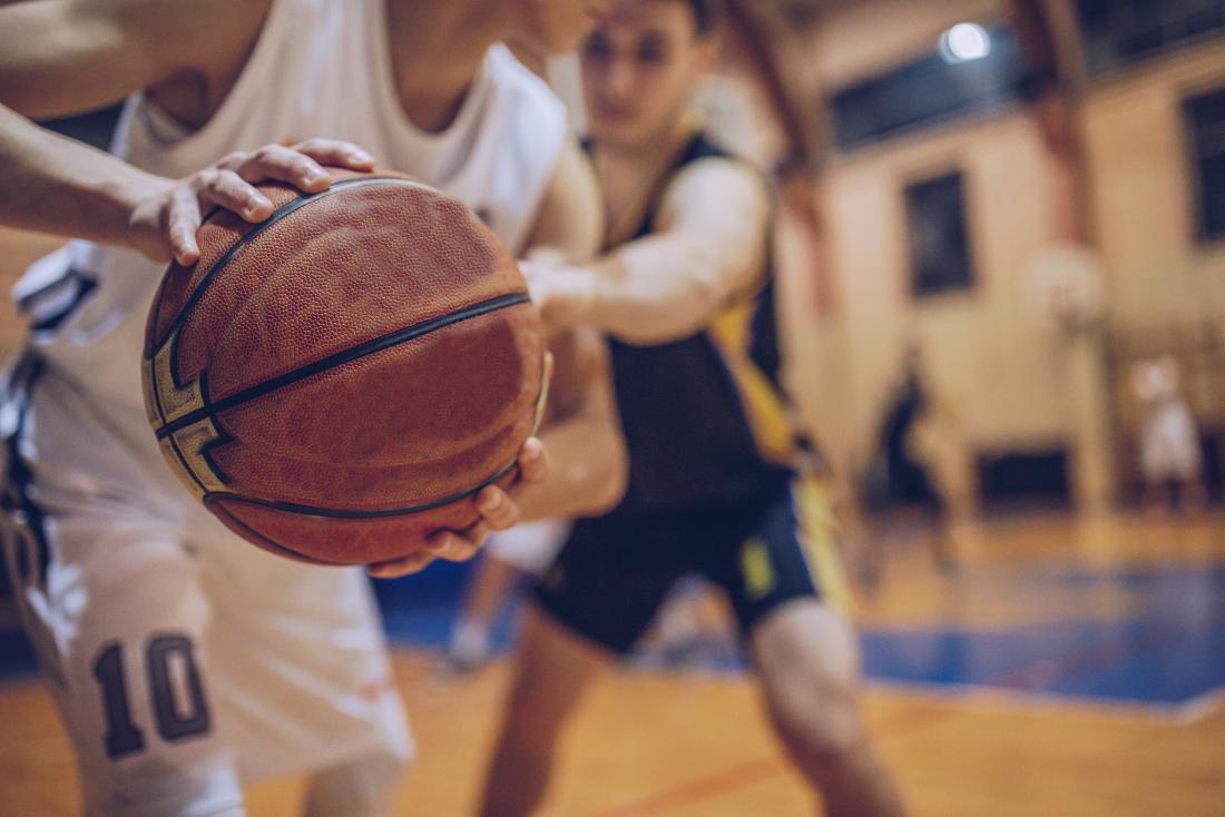 People playing basketball on court.