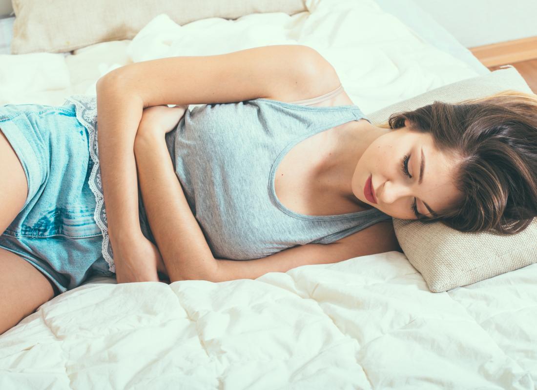 Woman holding her stomach with possible endometritis