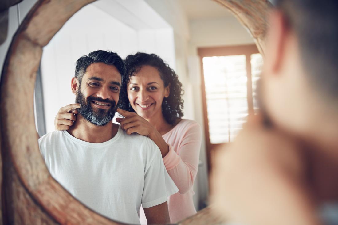 couple smiling in the mirror