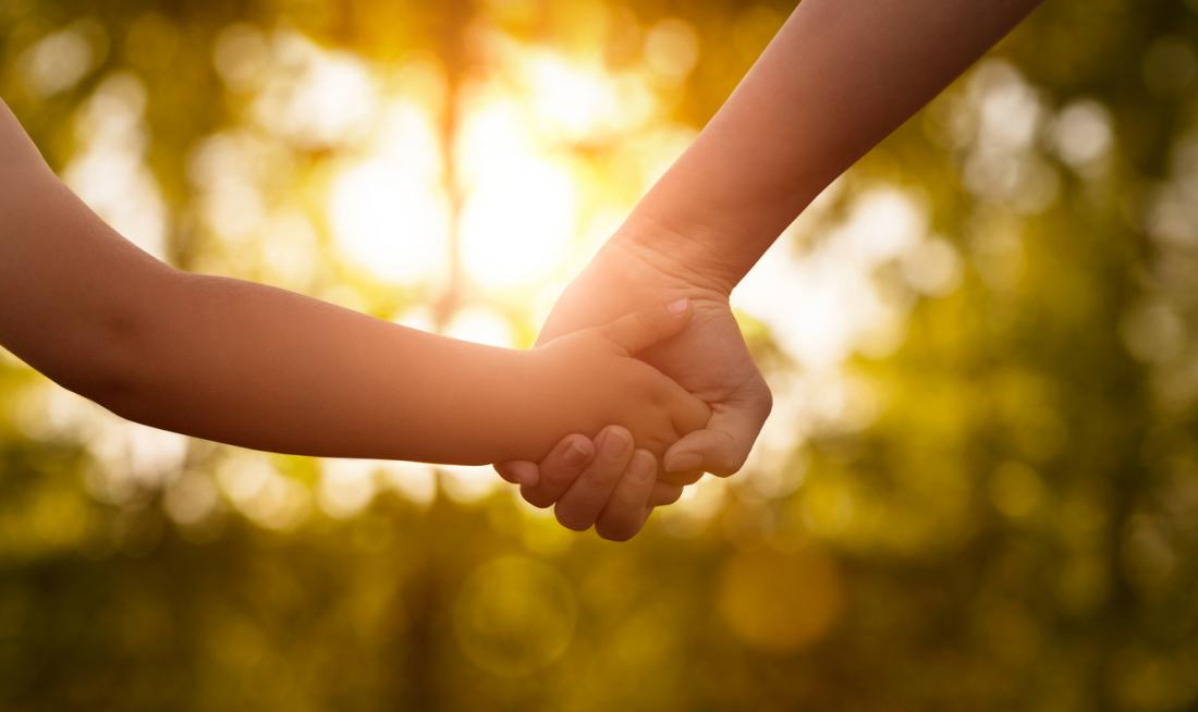 mother holding childs hands