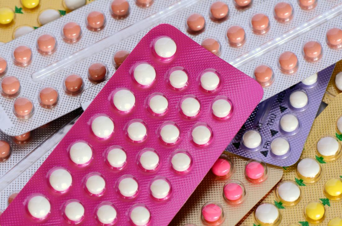 Packs of hormonal birth control pills piled up