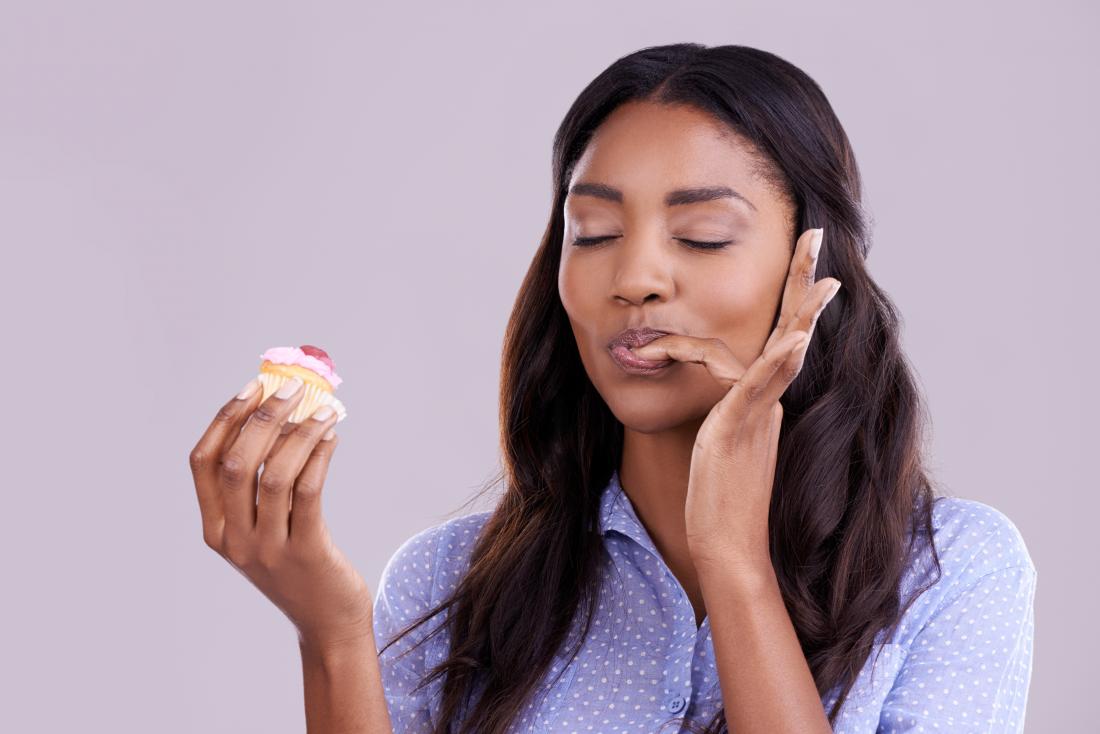 woman enjoying cupcake