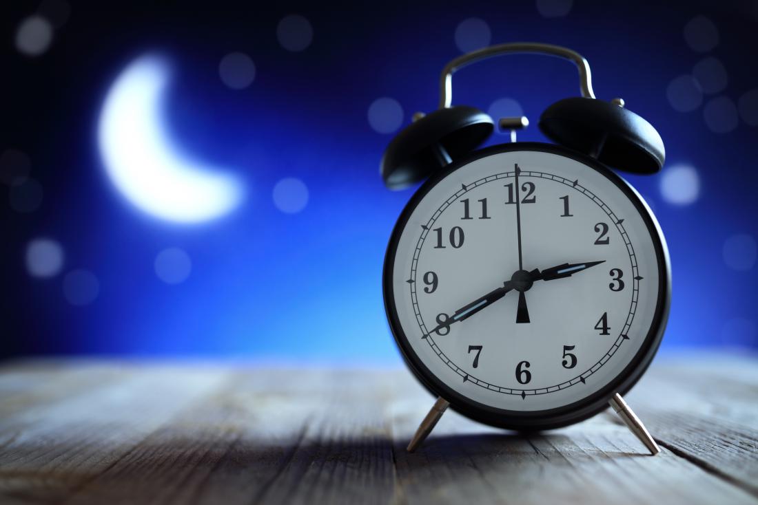 An alarm clock on a table at night