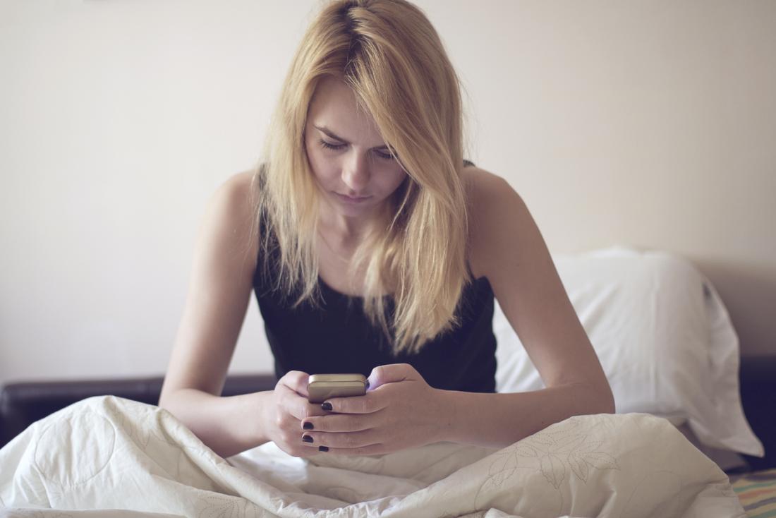 woman with depression looking at phone