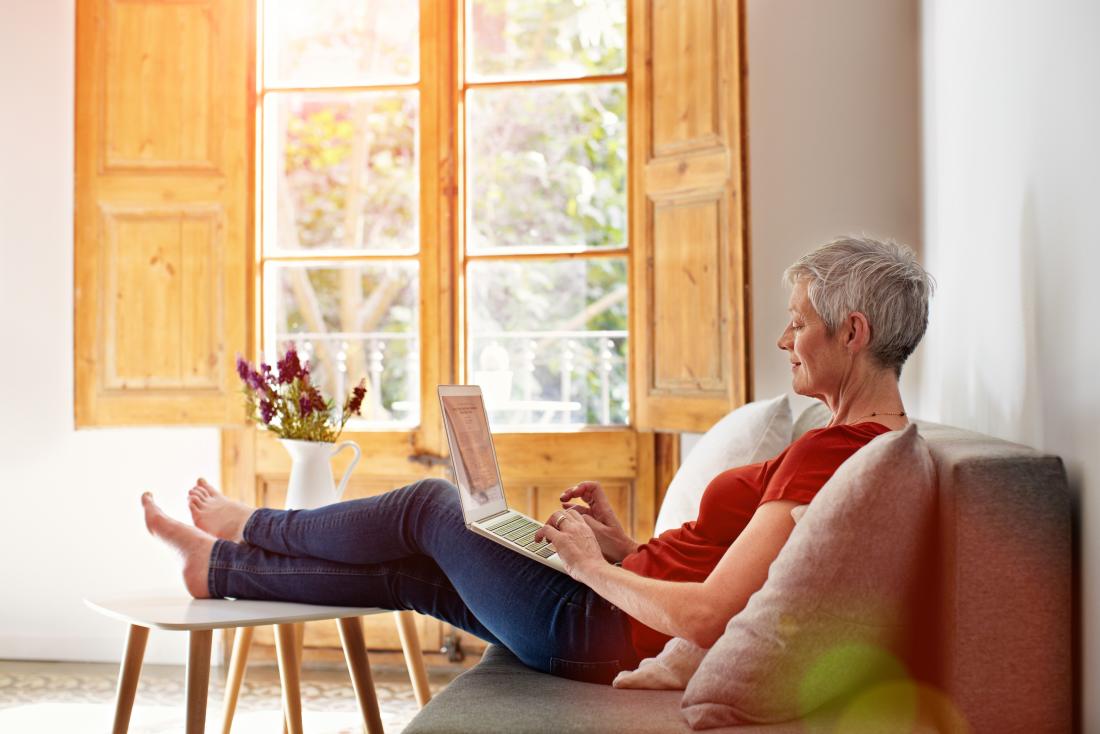 older woman sitting with laptop