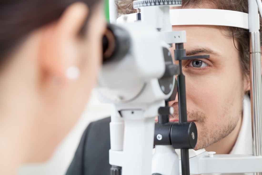 man having eye exam at opticians