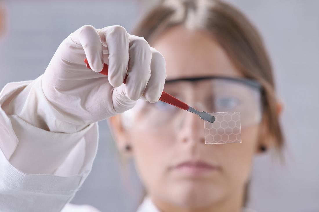 scientist holding a piece of graphene