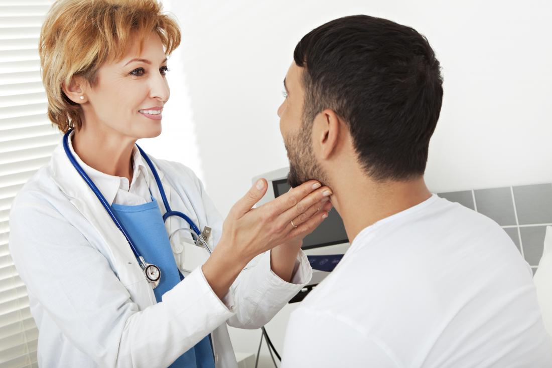 Dermatologist inspecting patients face.