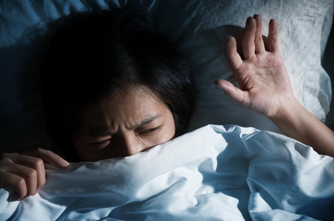 terrified woman in bed