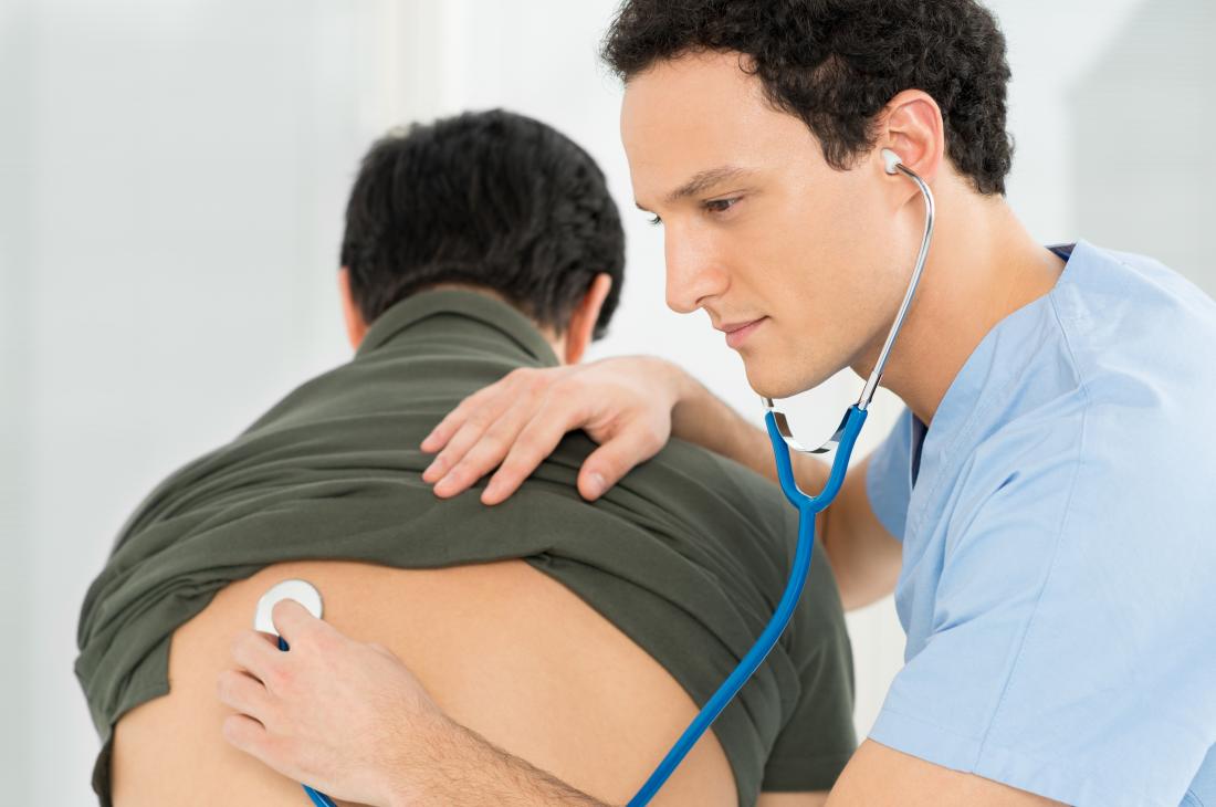 doctor listening to patients lungs