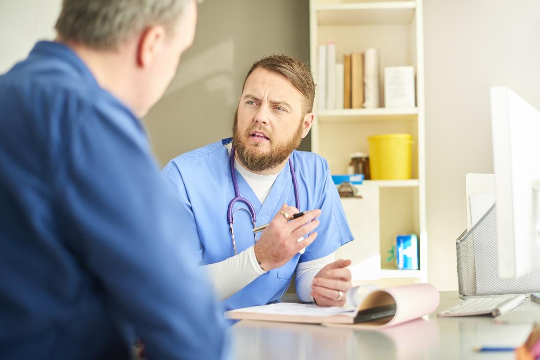 Doctor speaking to patient in office.