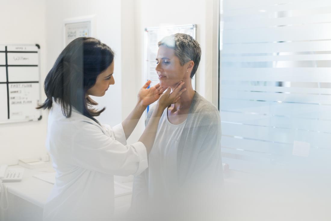 lymph nodes being felt by doctor
