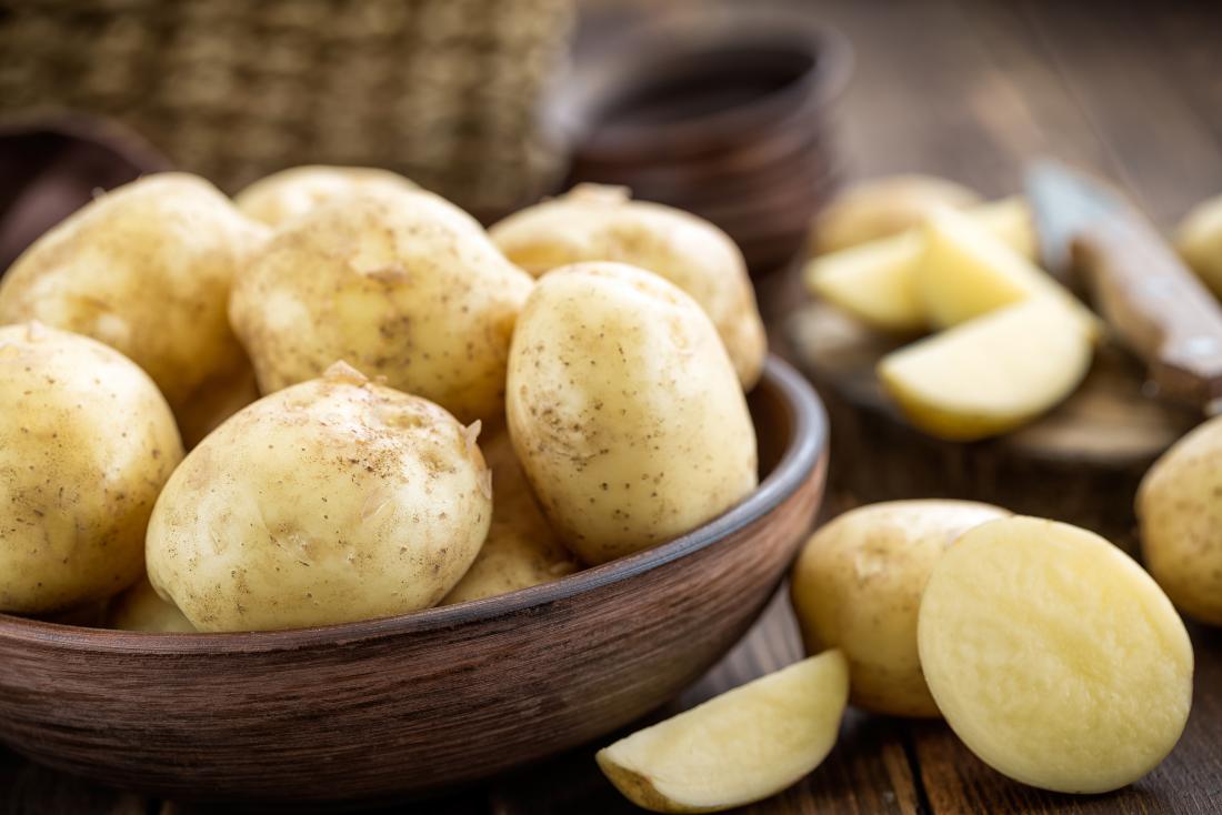 White potatoes in wooden bowl.