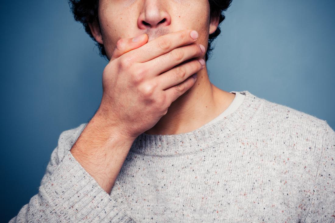 Man covering his mouth with his hand