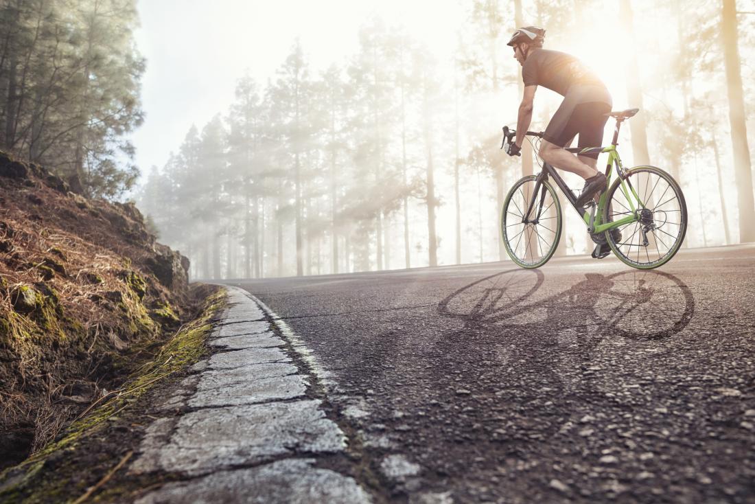 man cycling on road
