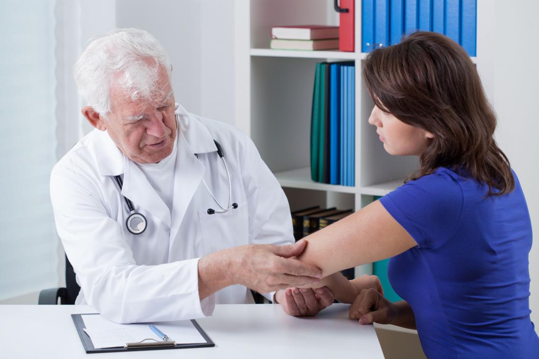 Person at doctor's having check for psoriatic arthritis.