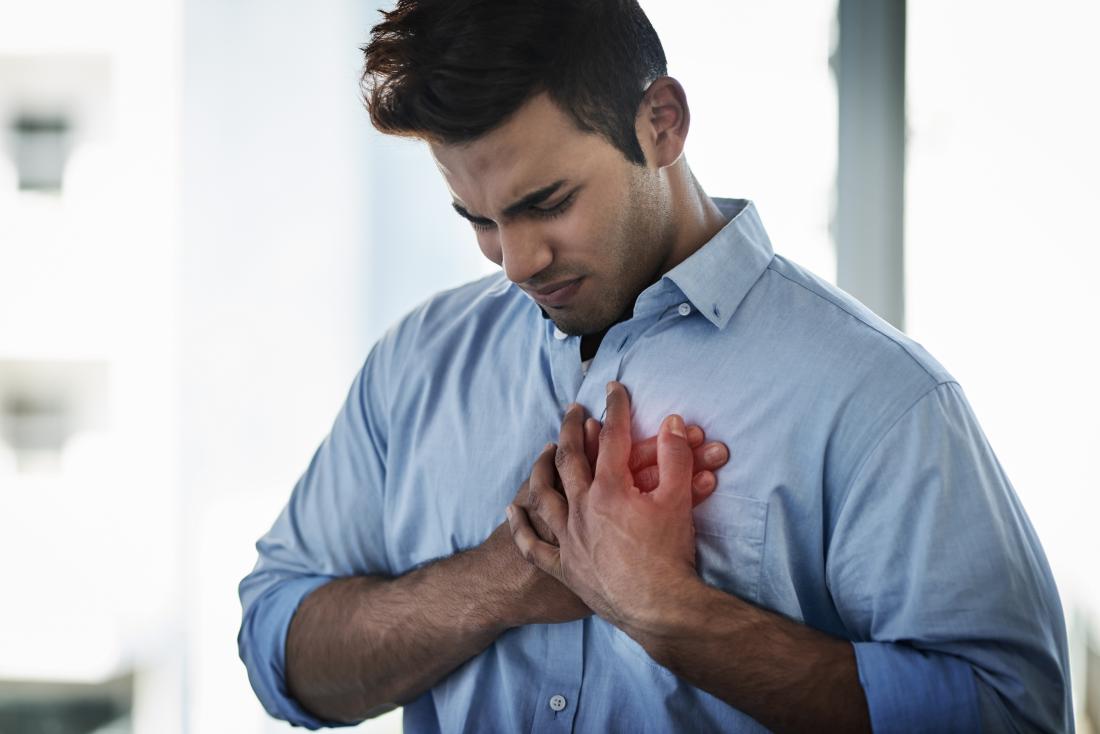 man holding his chest due to pneumomediastinum
