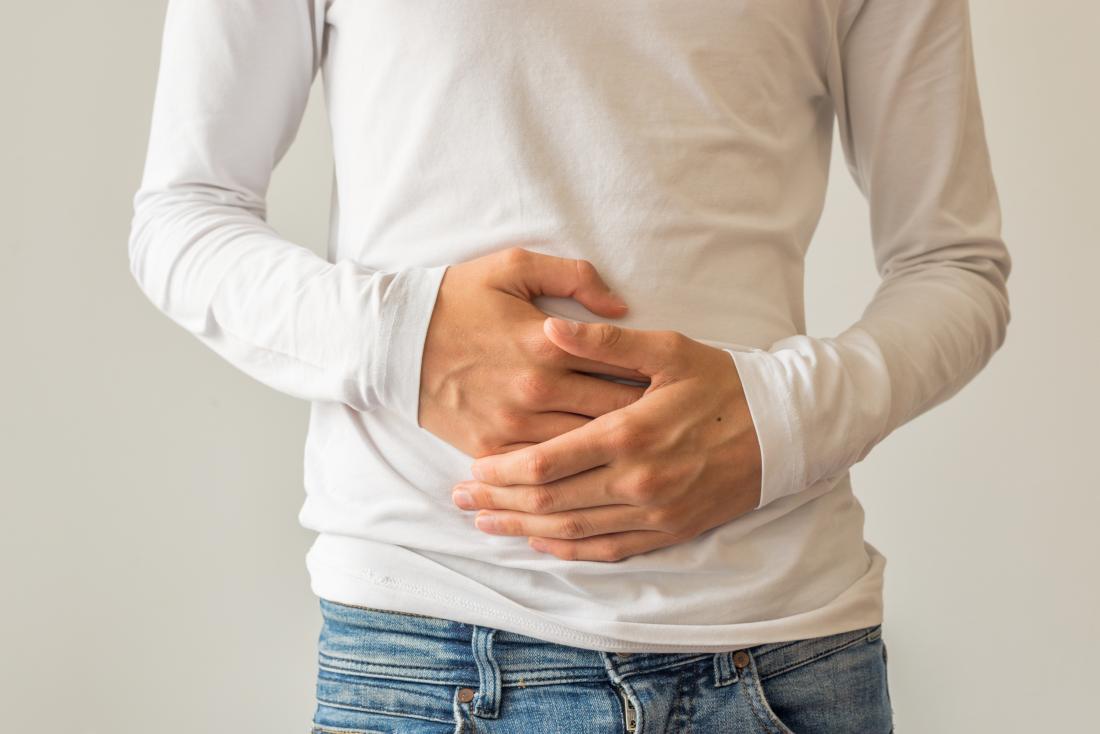 man holding stomach in pain.