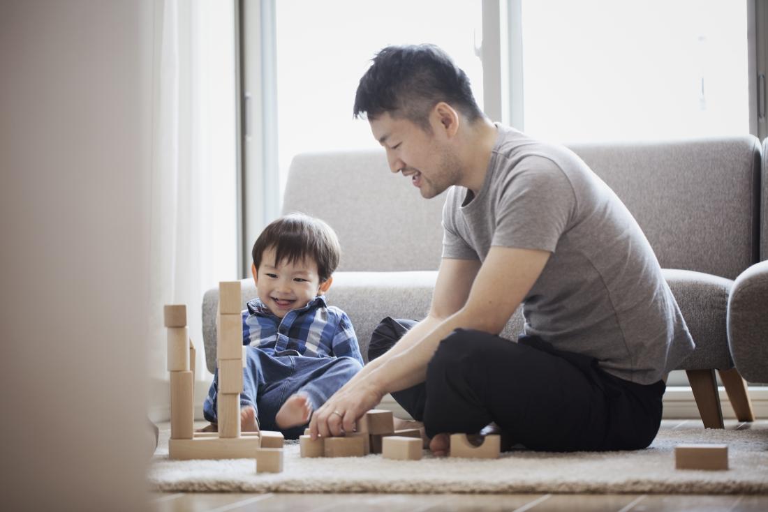 Father and son playing with building blocks together