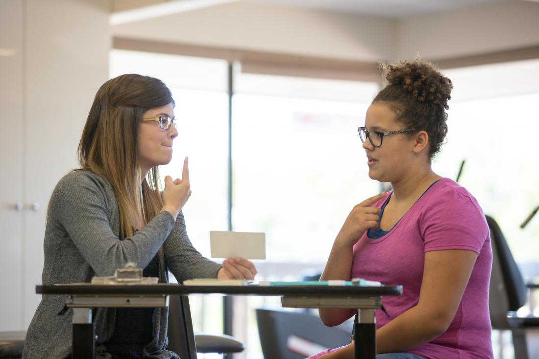 speech therapist speaking with patient to help her stop stuttering