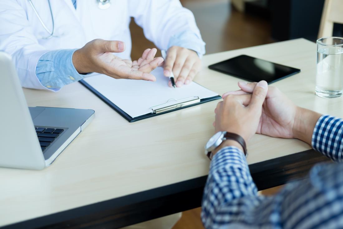 Doctor and patient discussing matter over desk.