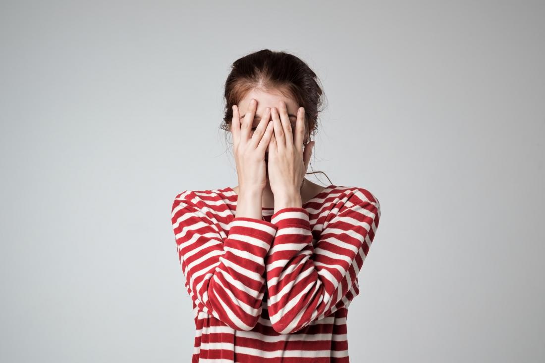 the woman covers her breasts with her hand. without face Stock Photo