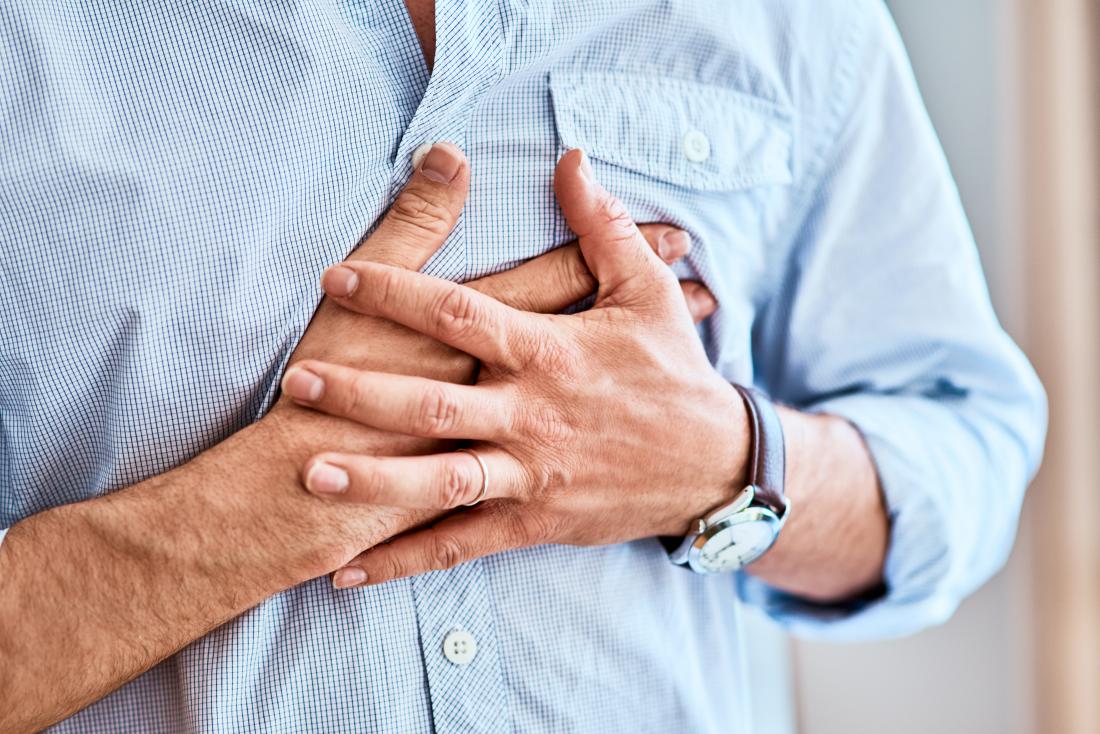 Man clutching his chest in pain because of heart attack