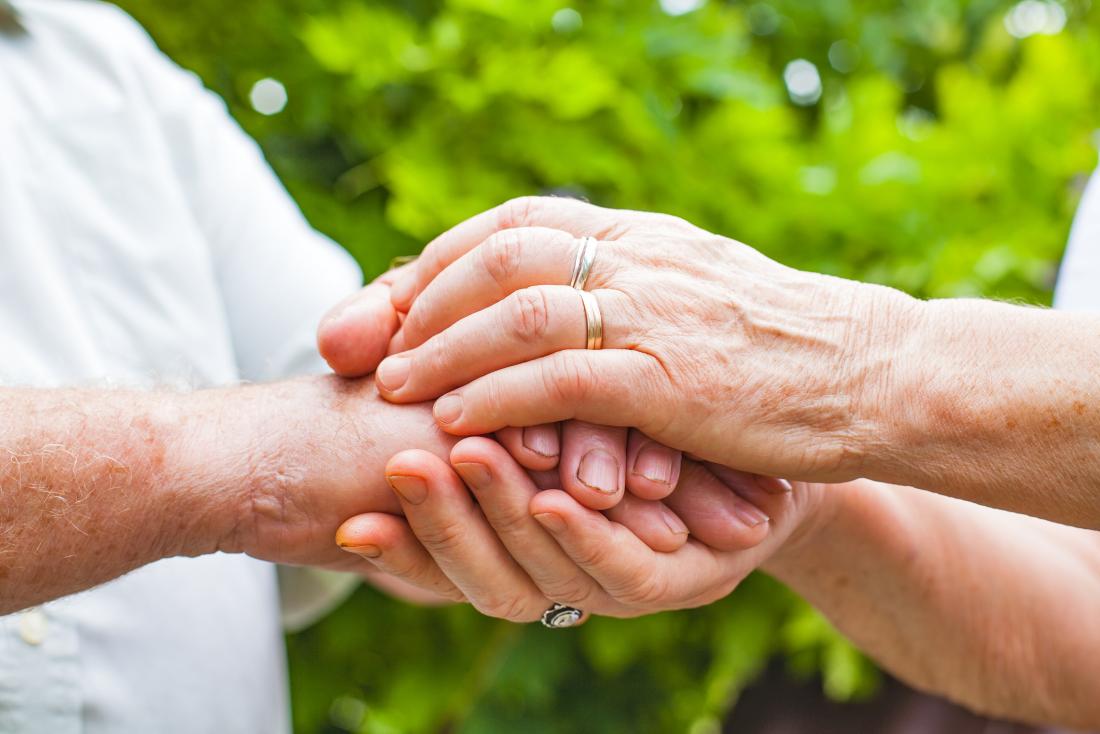 Older adults holding hands