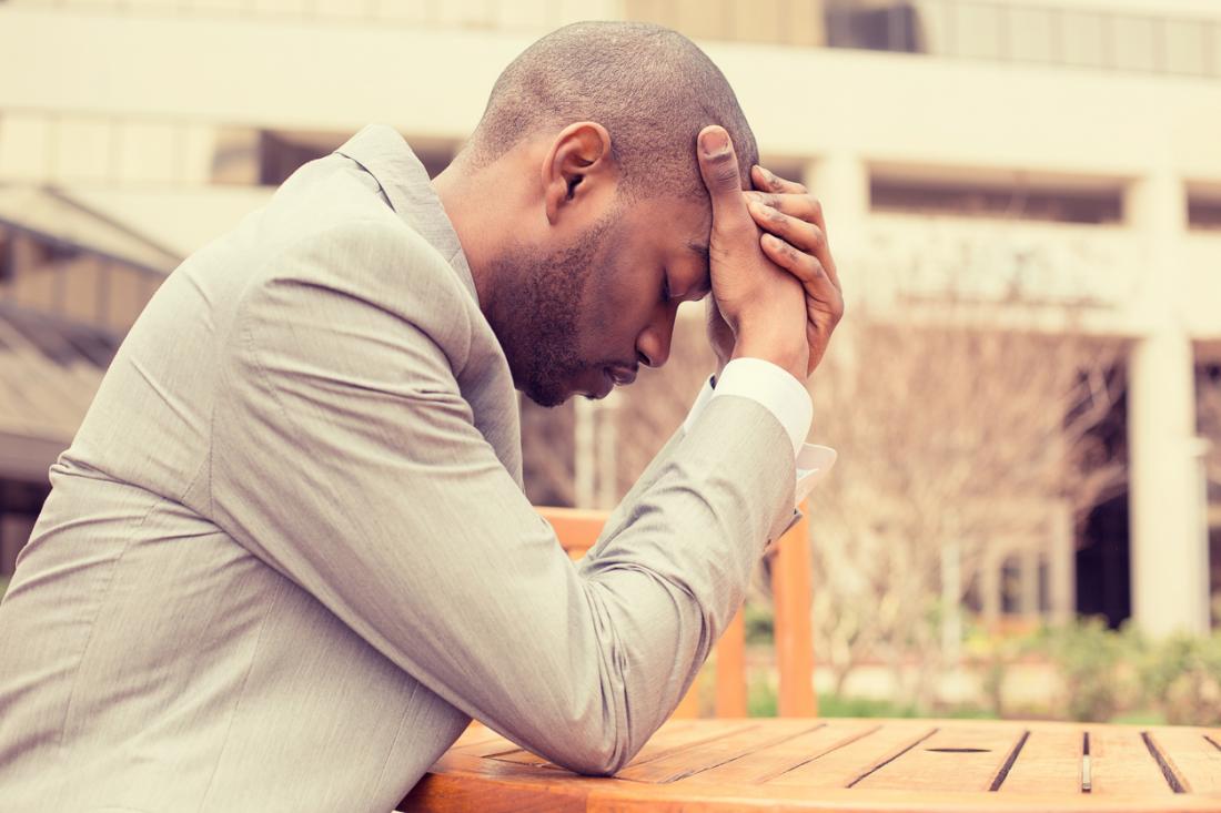 stressed man with head in hands