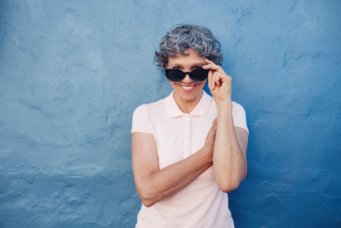 senior lady lowering her sunglasses