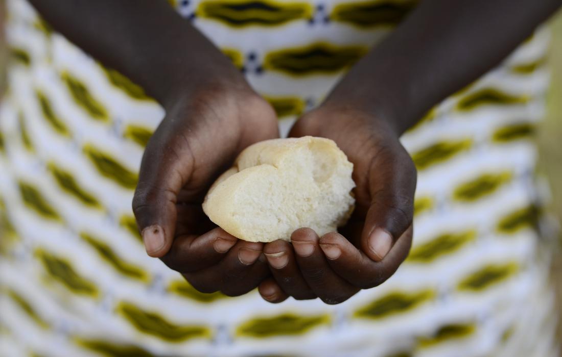 person holding bread representing malnutrition and famine.
