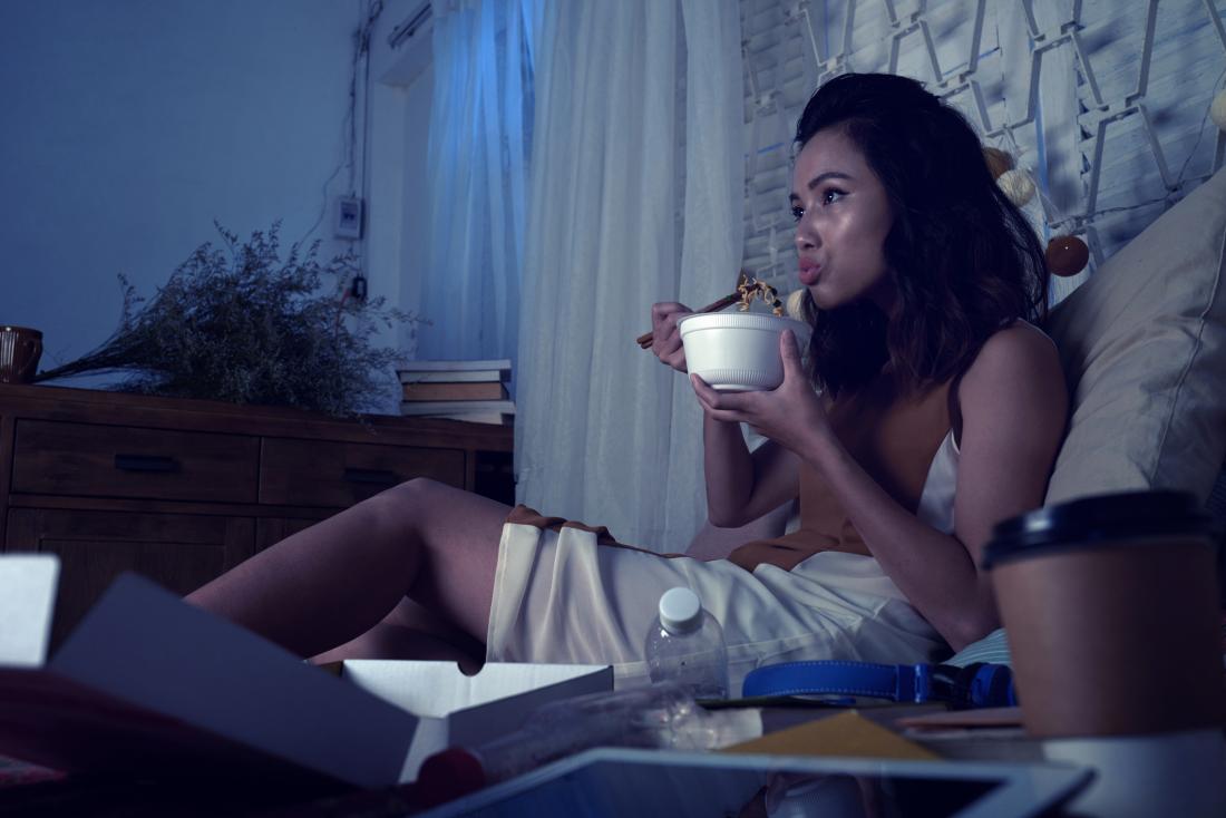 Woman eating at night