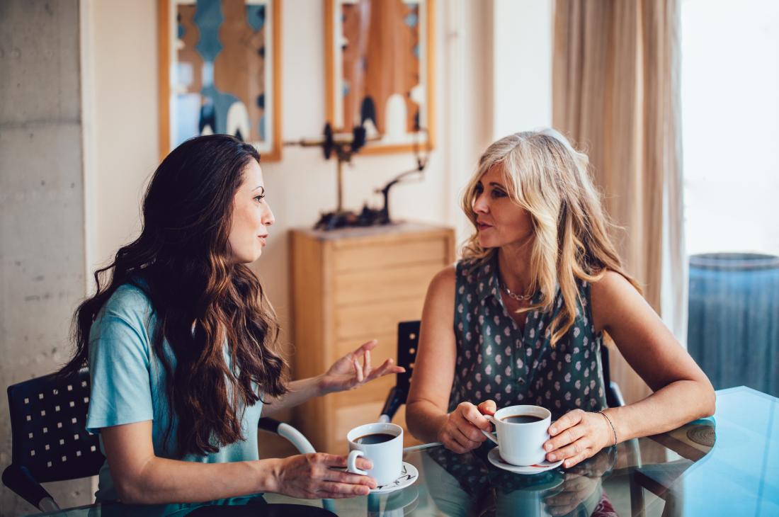 Mother and daughter chatting over coffee