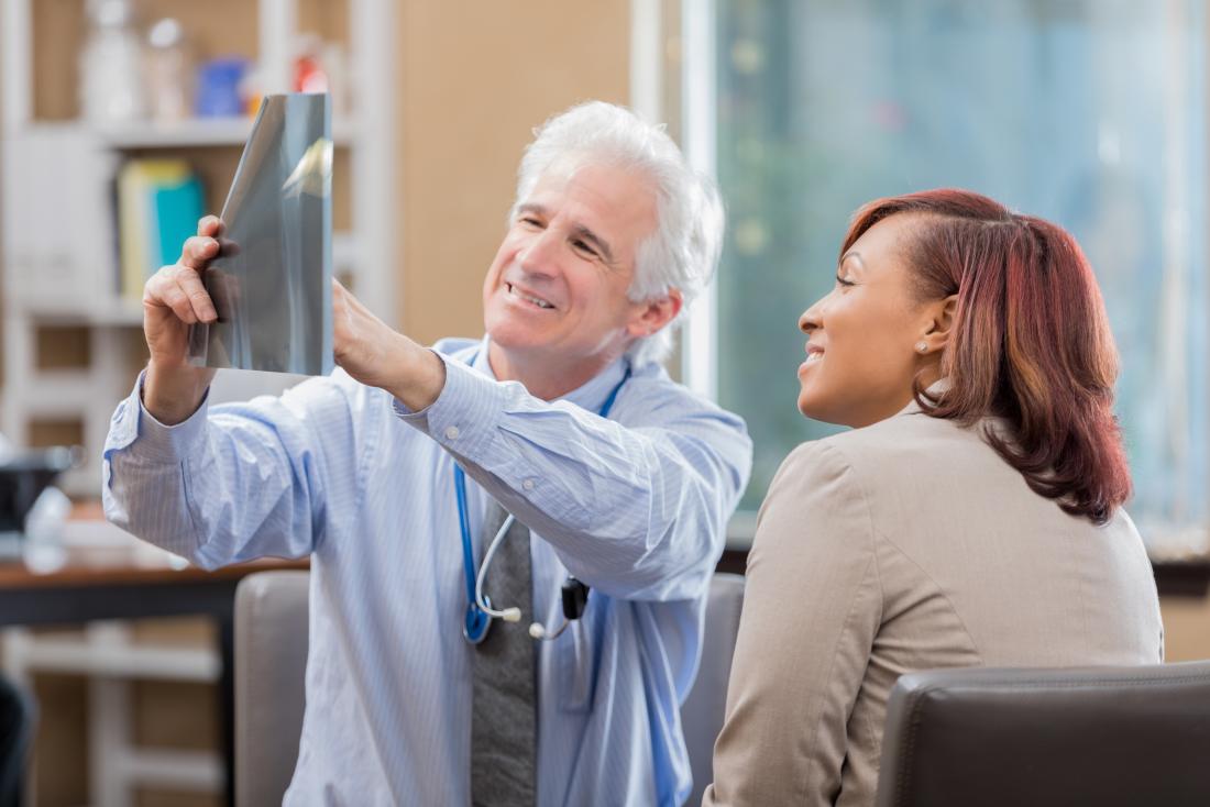 consultant & patient looking at X-rays