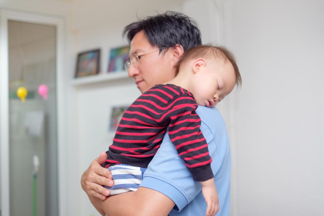 Toddler being held by father fallen asleep