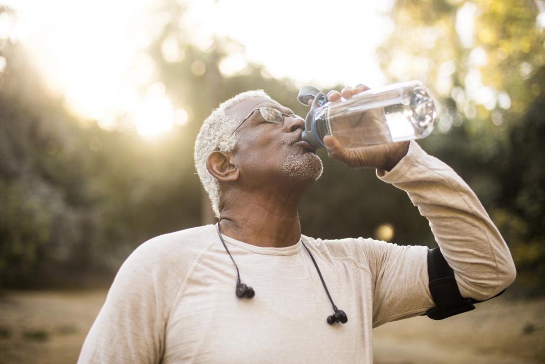Senior male drinking water