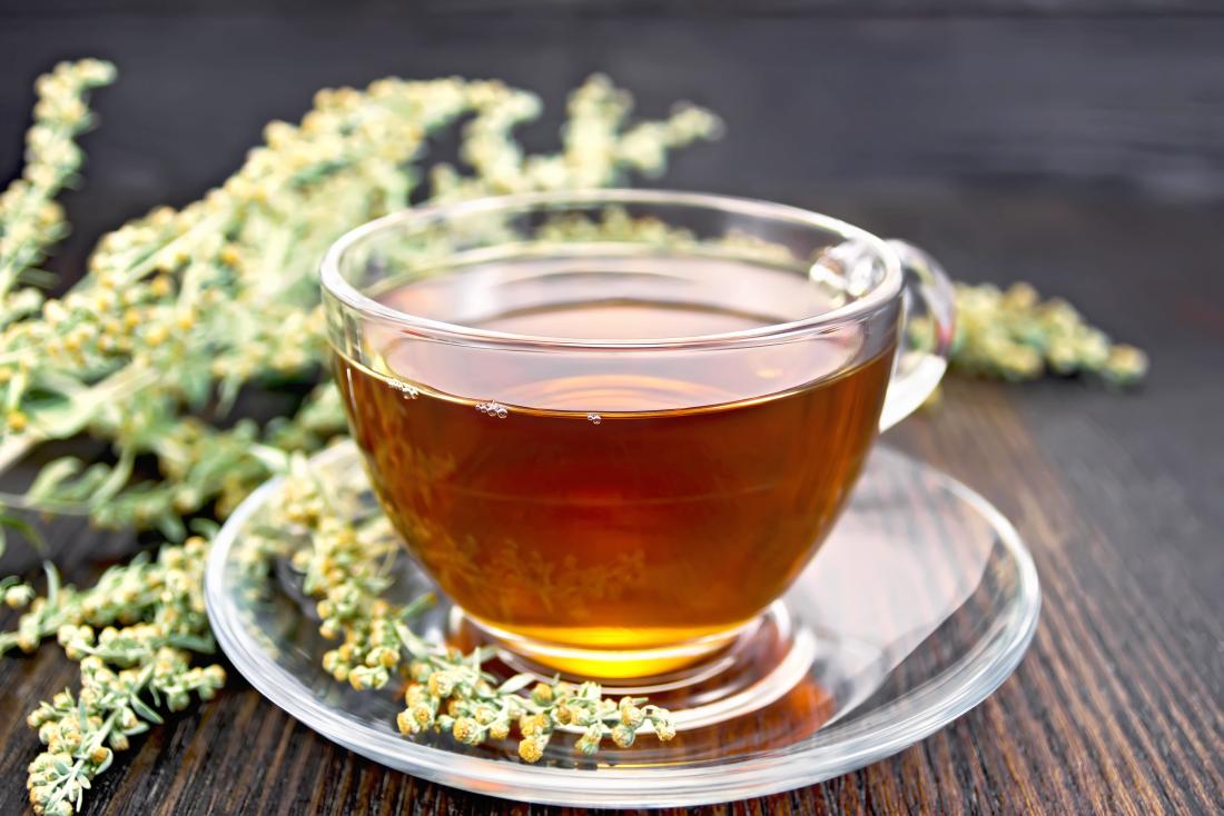 https://cdn-prod.medicalnewstoday.com/content/images/articles/322/322714/mug-of-tea-in-front-of-wormwood-plant-or-flower-on-wooden-table.jpg