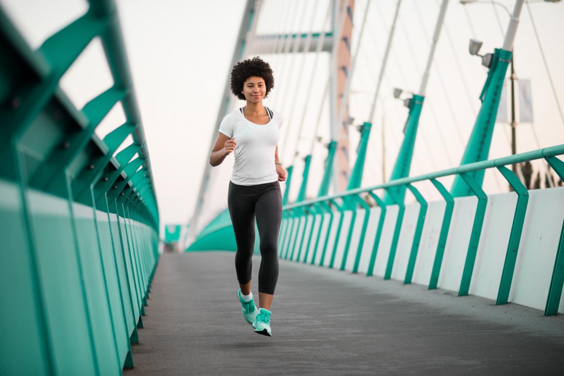 Woman jogging or running on bridge
