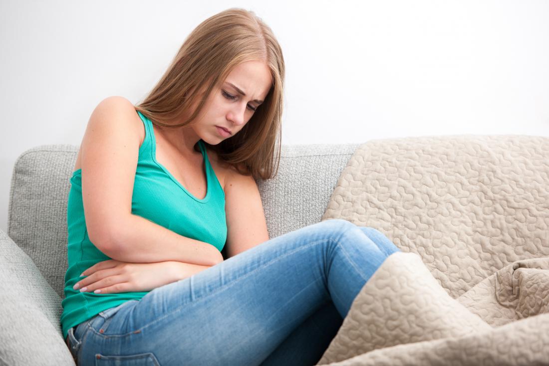 Woman holding stomach due to nausea