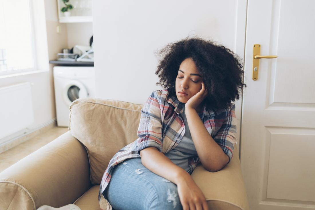 sleepy young woman sitting on armchair