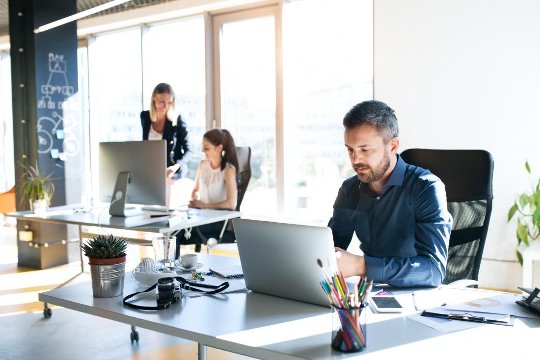 Office workers sitting at desks in front of computers
